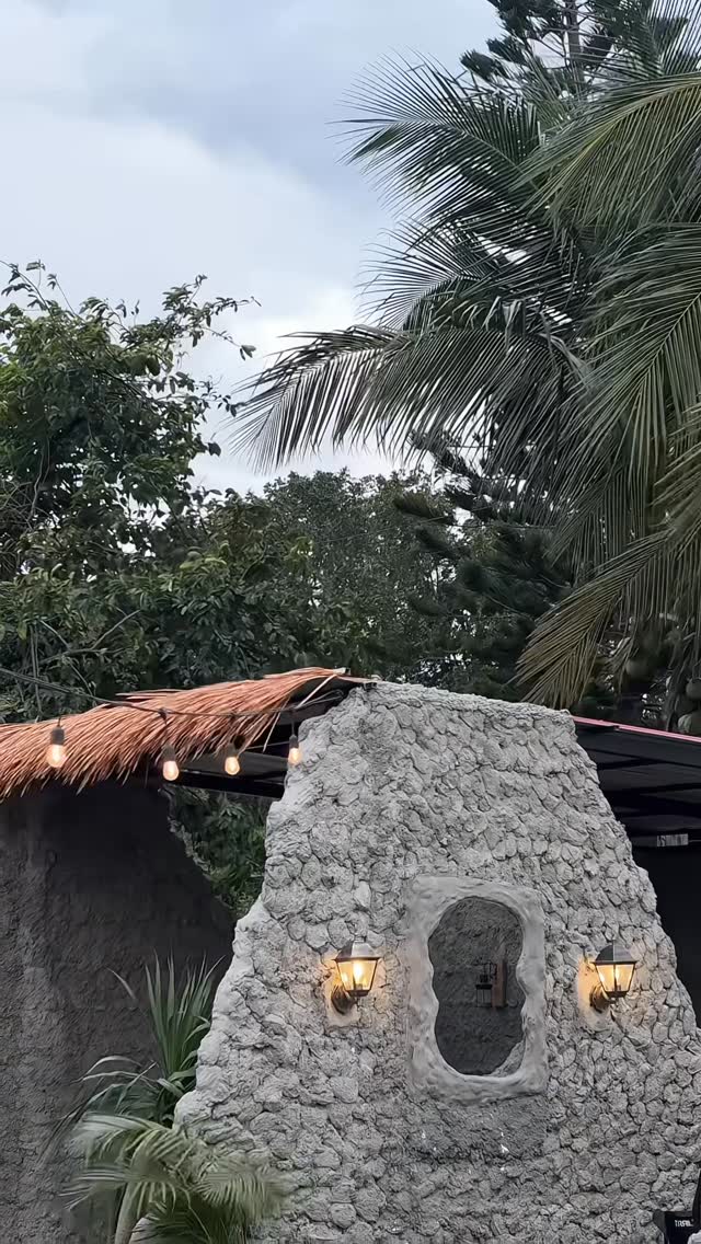 Moon Coffee stone entrance with lanterns and thatched roof